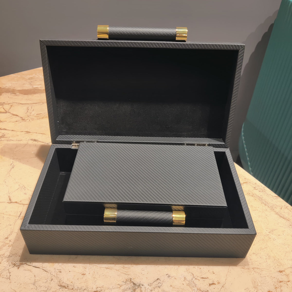 Luxury black leather jewelry box with elegant gold handle detailing for premium watch and accessory storage organization