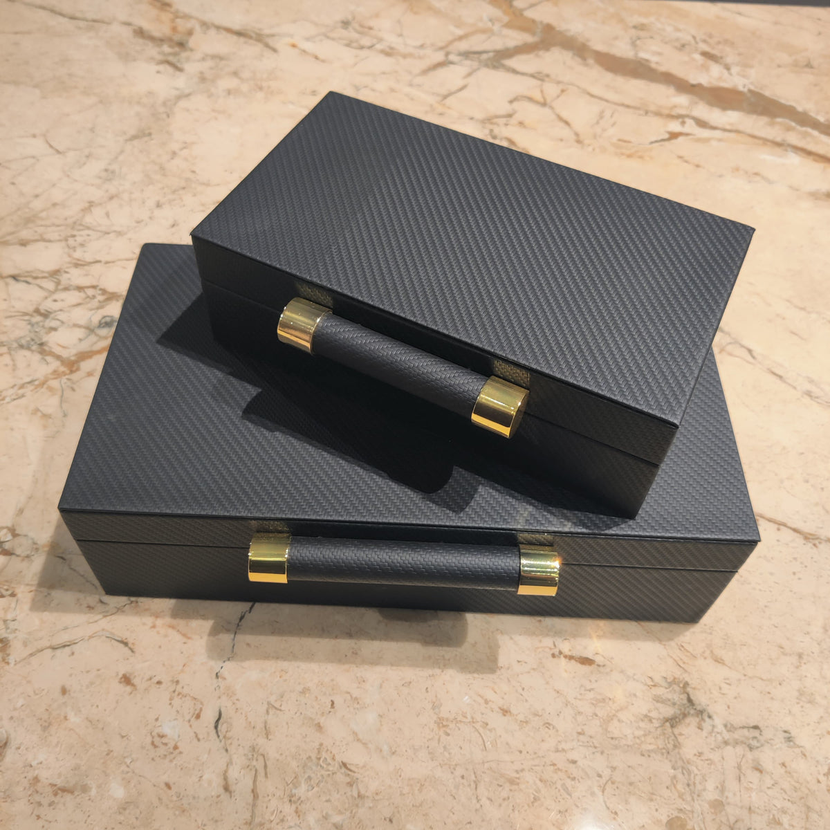 Luxury black leather jewelry box with elegant gold handle detailing for premium watch and accessory storage organization