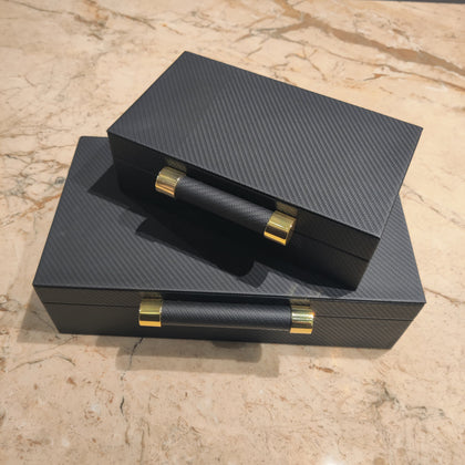 Luxury black leather jewelry box with elegant gold handle detailing for premium watch and accessory storage organization