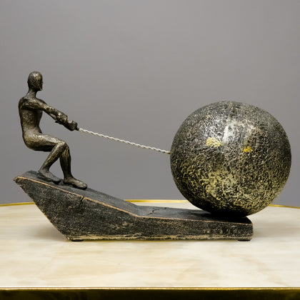 Bronze human figure pulling stone-textured sphere on incline sculpture – Struggle & Strength Classic