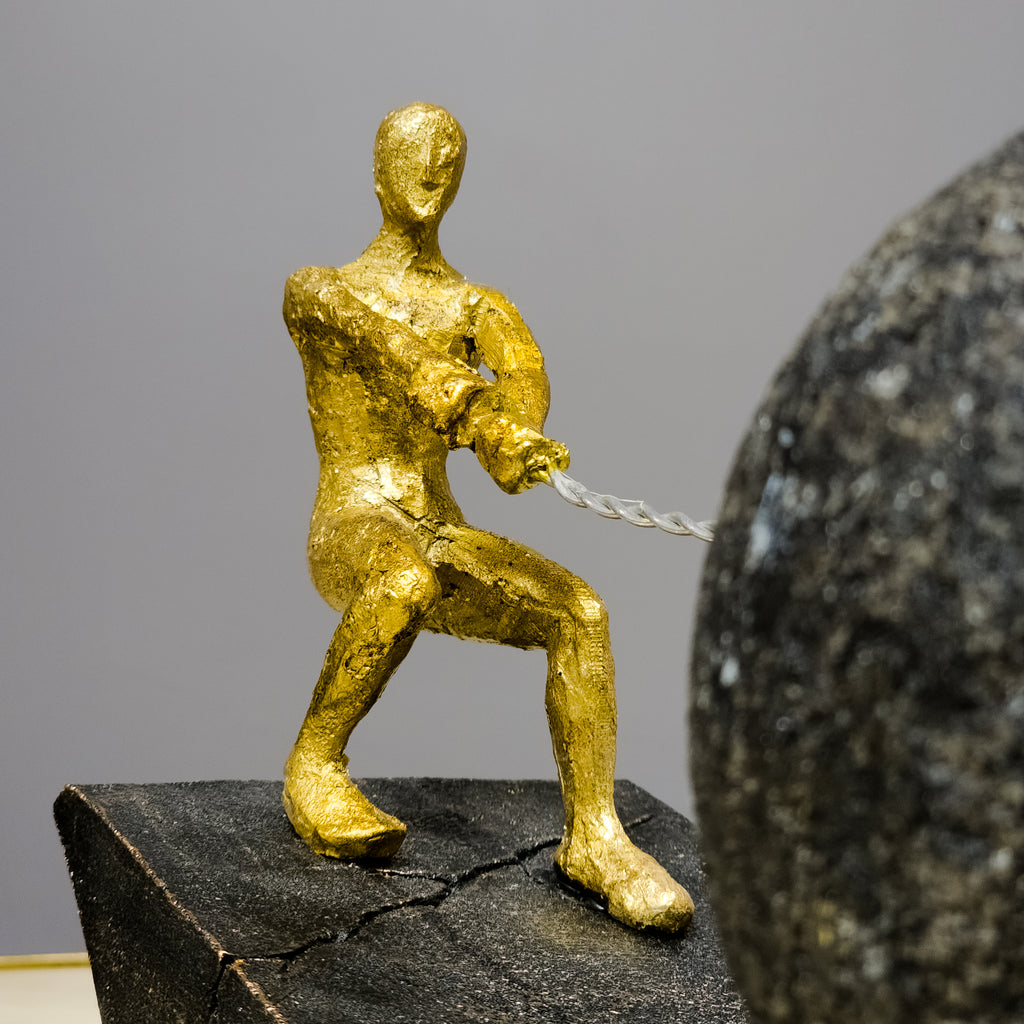 gold abstract human figure decor pulling sphere modern tabletop accent