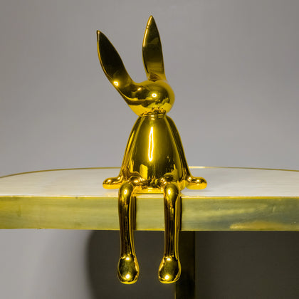 Designer gold bunny figurine with elongated legs and artistic contemporary styling for luxury interiors