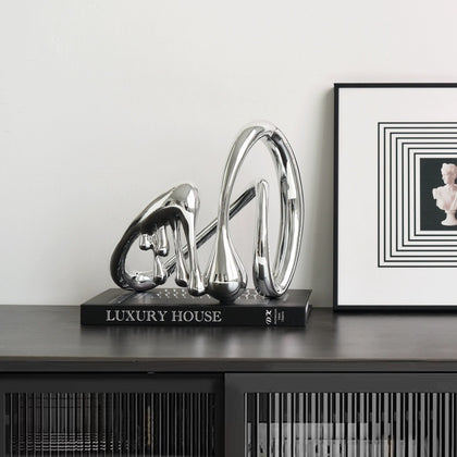 Flowform on book beside framed art, console