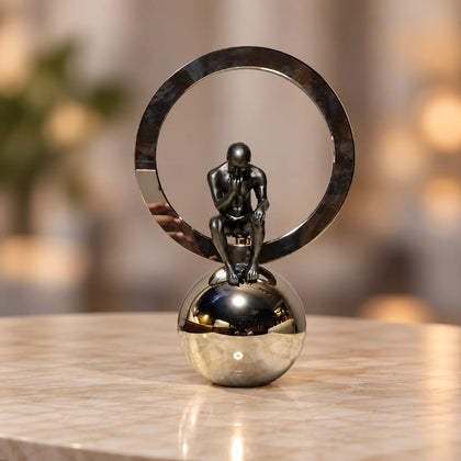 modern abstract human figurine decor with metallic ring and reflective sphere base