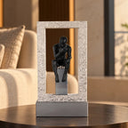 A premium black resin and metal sculpture of a contemplative thinker seated in reflection with a sturdy base, ideal for home and office decor.