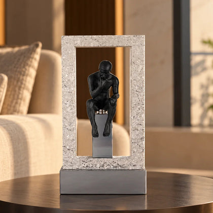 A premium black resin and metal sculpture of a contemplative thinker seated in reflection with a sturdy base, ideal for home and office decor.