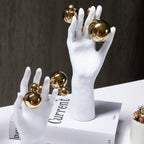 Abstract right hand on books, gold spheres
