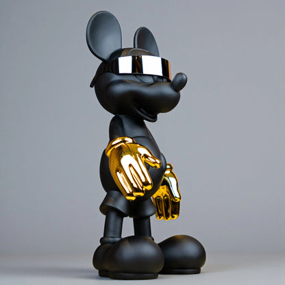 Black matte mascot figurine with gold gloves and chrome visor — Cyberpunk Mascot by Ghar Art, futuristic luxury tabletop decor sculpture.