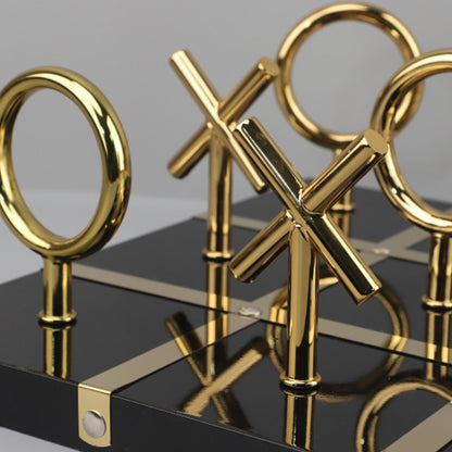 Tic-tac-toe set close-up, black board gold X