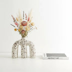 Terra Arch w/ florals beside art book