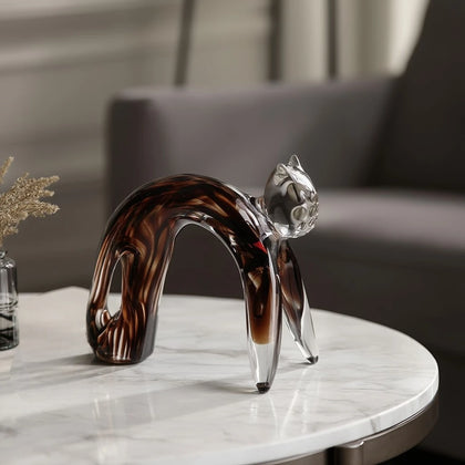 Glass cat amber swirl on marble side table