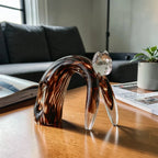 Glass cat arched amber on wood w/ magazine