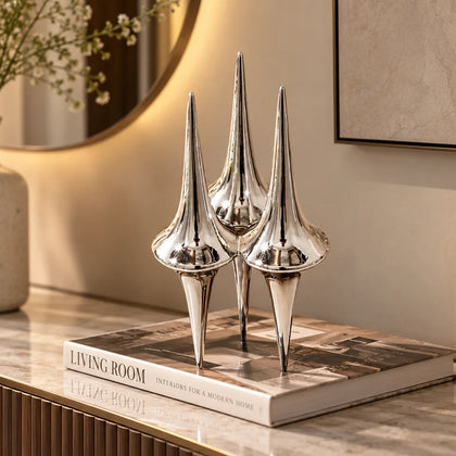 Chrome droplet column trio on coffee book