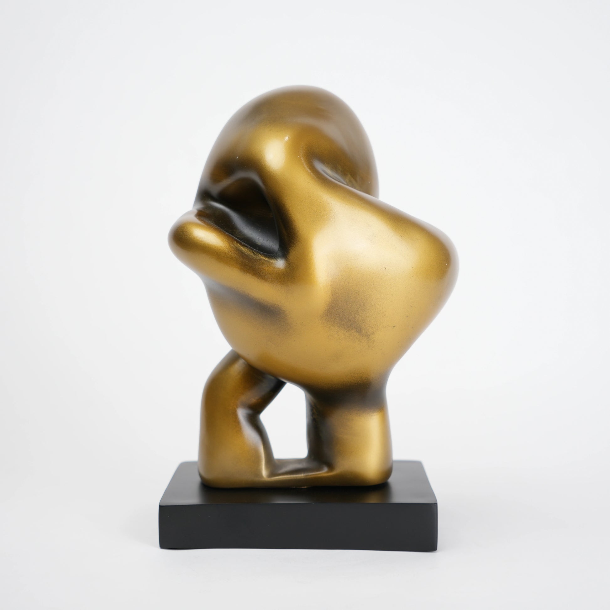 Abstract human decor object in matte gold finish with black base for modern home styling