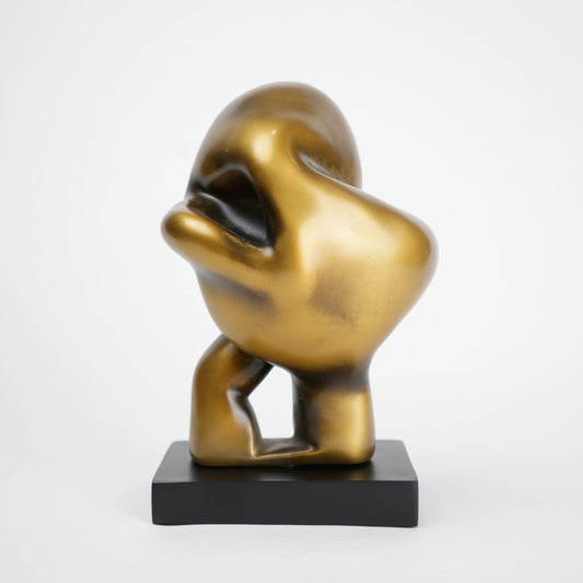 Abstract human decor object in matte gold finish with black base for modern home styling