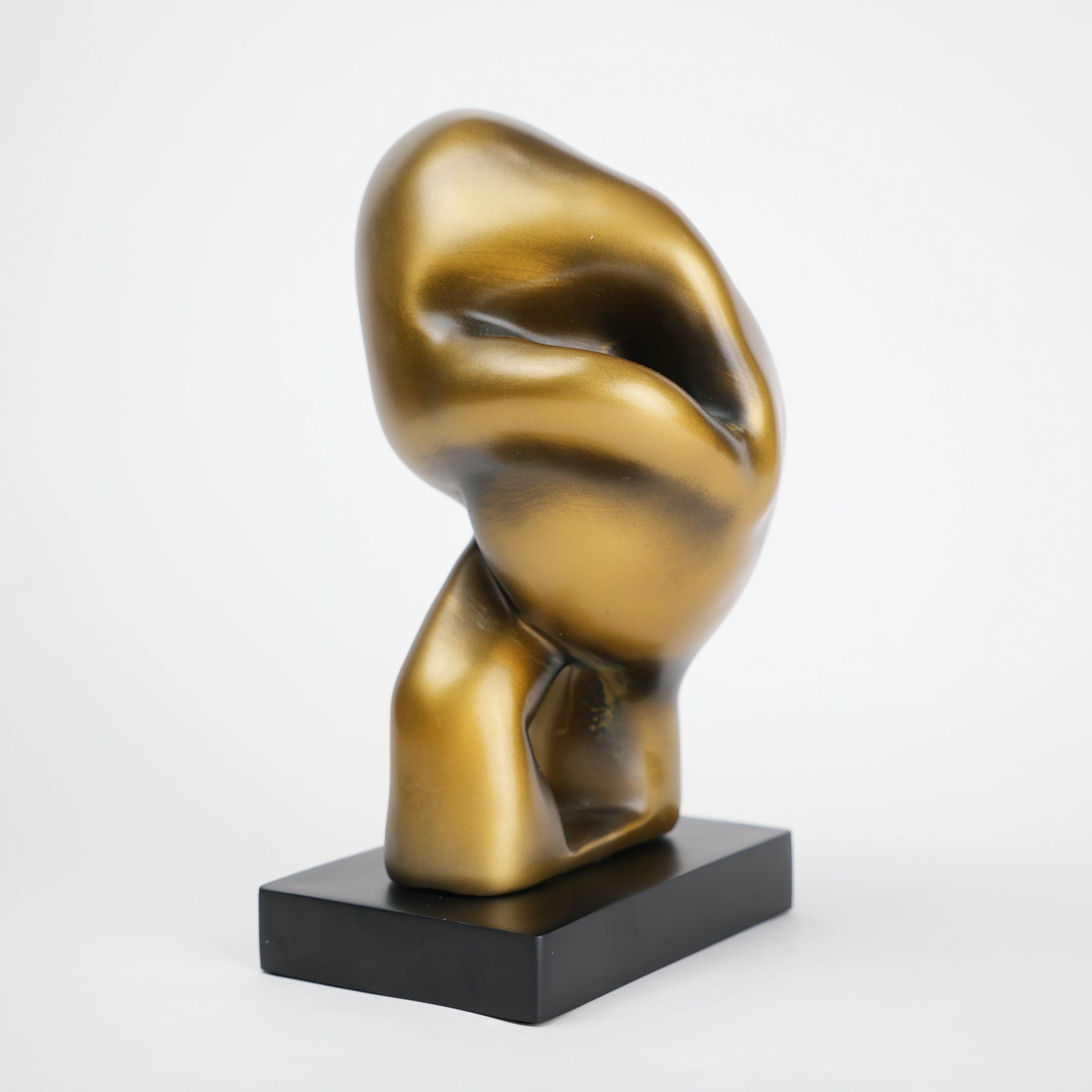 Abstract human decor object in matte gold finish with black base for modern home styling
