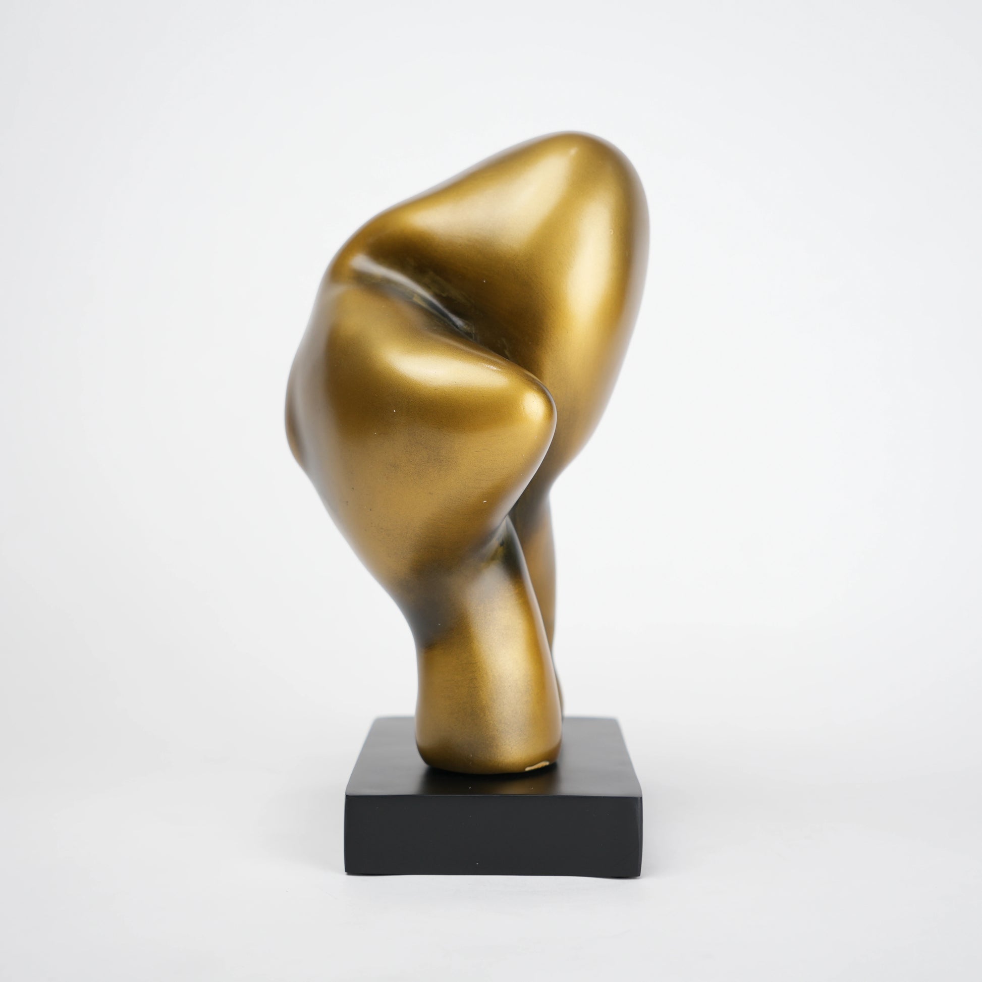 Abstract human decor object in matte gold finish with black base for modern home styling
