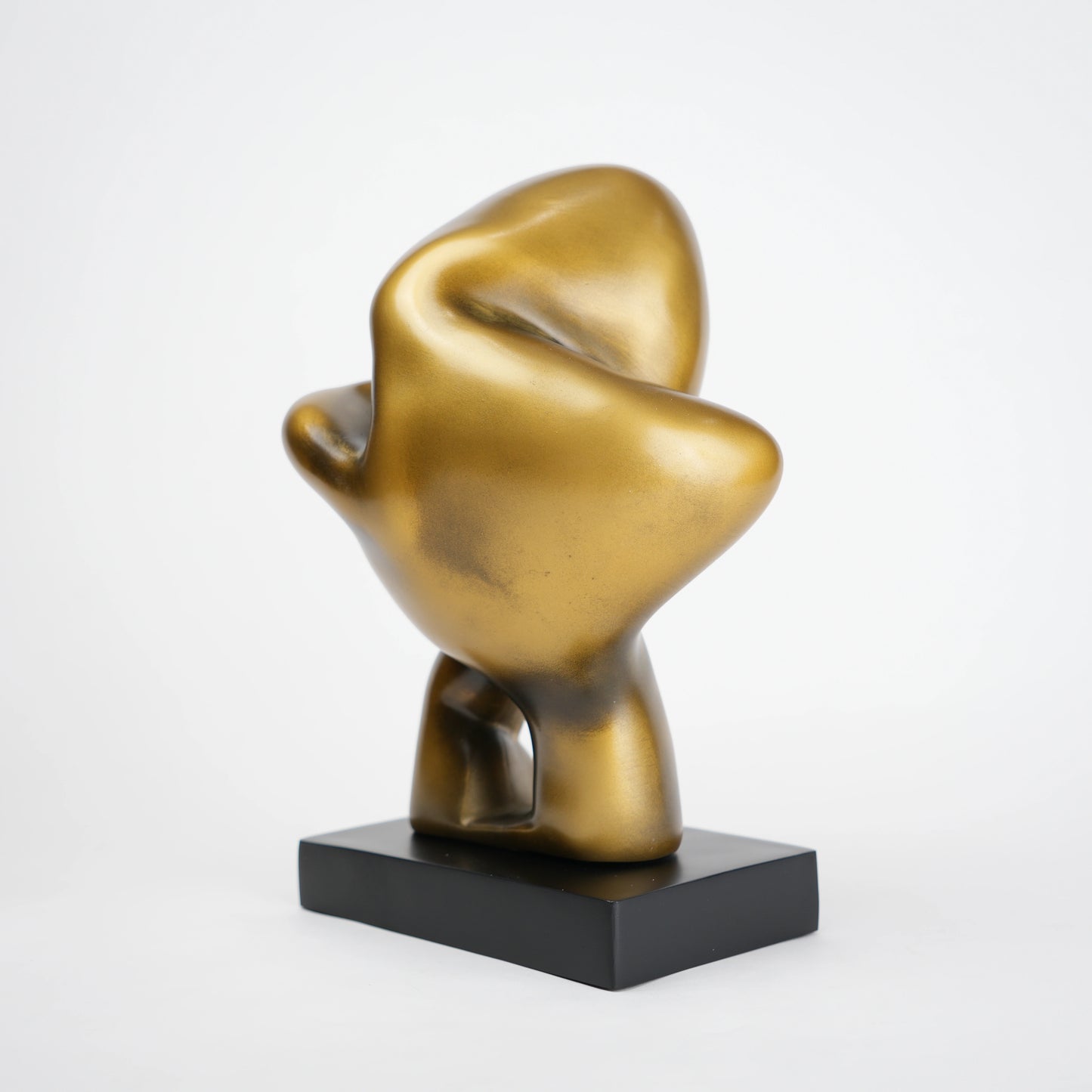 Abstract human decor object in matte gold finish with black base for modern home styling