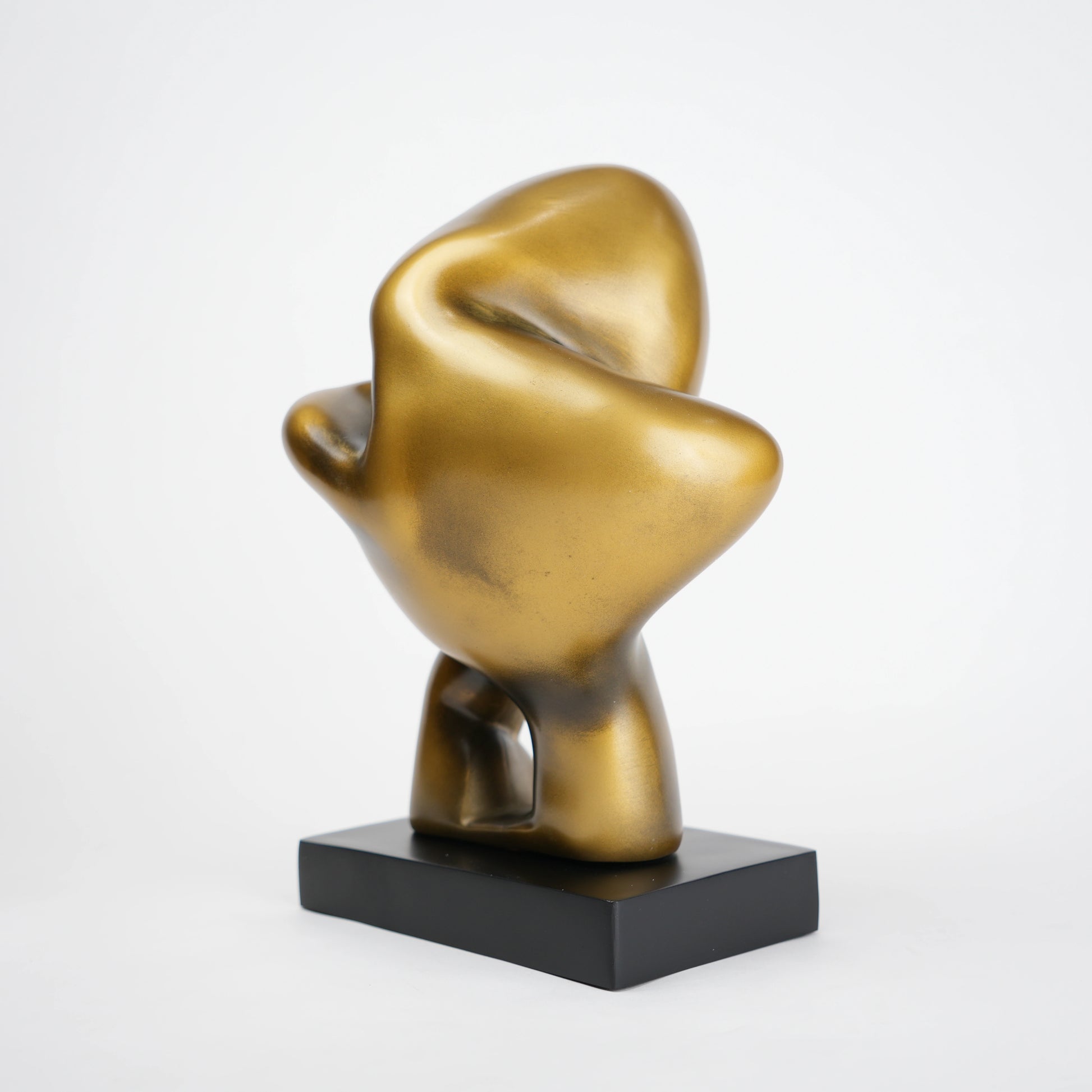 Abstract human decor object in matte gold finish with black base for modern home styling