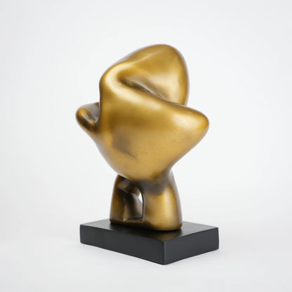 Abstract human decor object in matte gold finish with black base for modern home styling