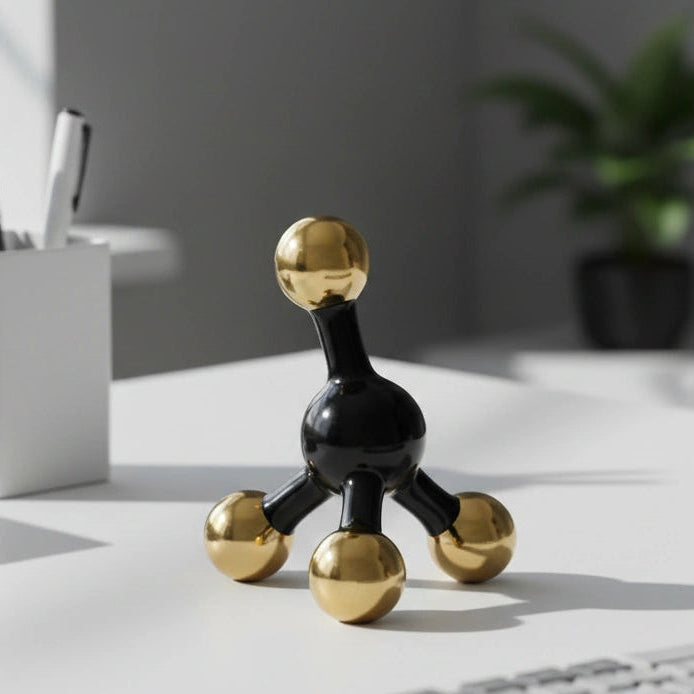 Decorative black and gold sculpture on a desk with office items in the background