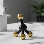 Decorative black and gold sculpture on a desk with office items in the background