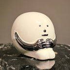 Contemporary resin figurine with polished chrome finish showcased as a modern artistic decor statement piece