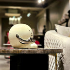 Contemporary resin figurine with polished chrome finish showcased as a modern artistic decor statement piece