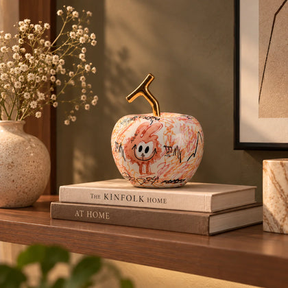 Doodle apple decor with colorful artwork and gold stem for modern playful home styling