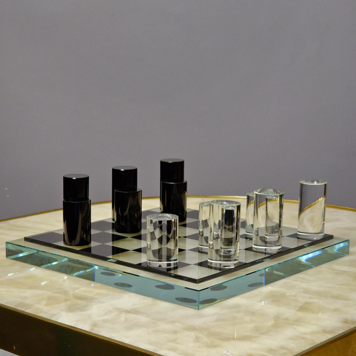 Sleek Glass Chess Set wide shot on onyx table