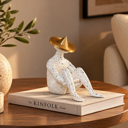 Modern abstract human figurine with artistic seated posture and metallic gold accent for luxury tabletop decor arrangements