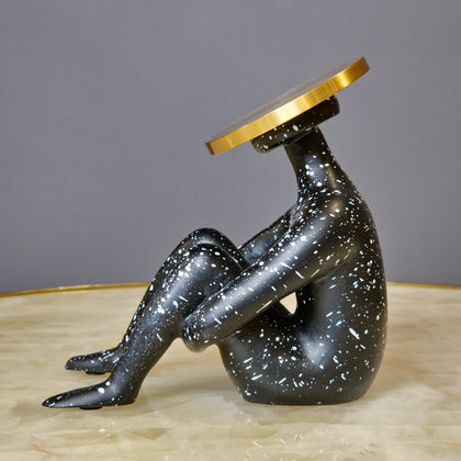 Luxury abstract seated human sculpture with black speckled finish and metallic circular head design for modern tabletop decor styling