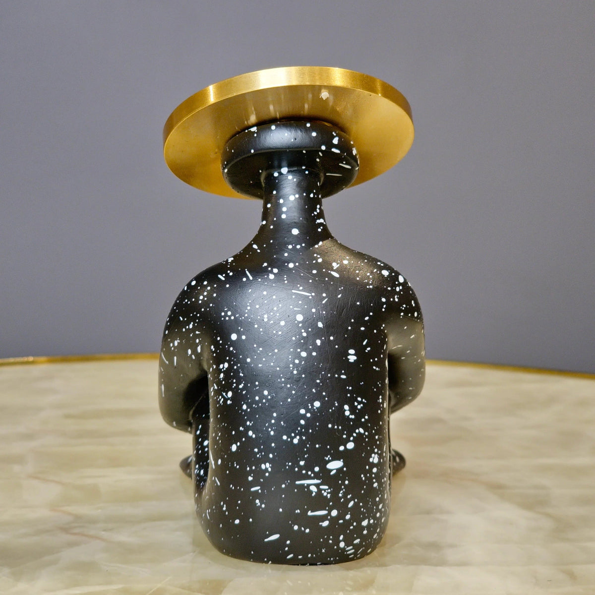 Contemporary abstract human figurine featuring artistic seated silhouette and textured black finish for luxury home decor interiors