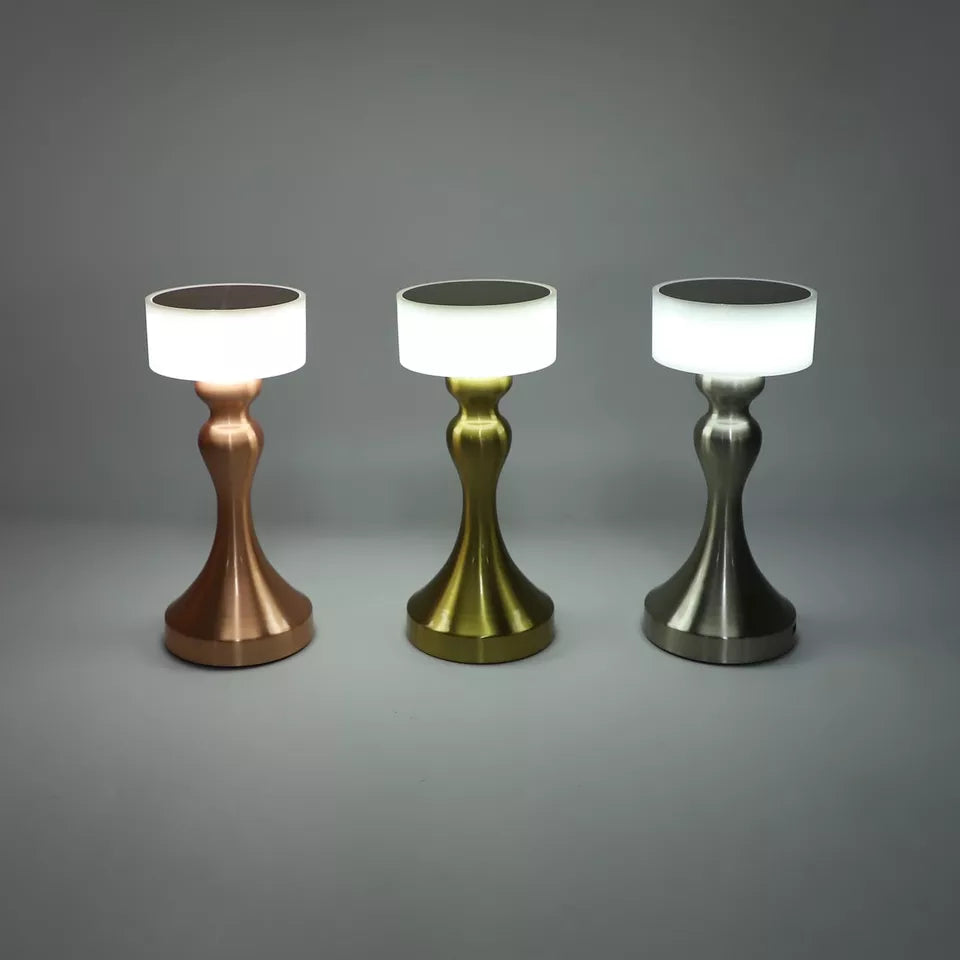Luxury cordless LED table lamp featuring a brushed gold metal base with a minimalist white lampshade, ideal for bedside tables, restaurants, cafés, living rooms and modern designer interiors.