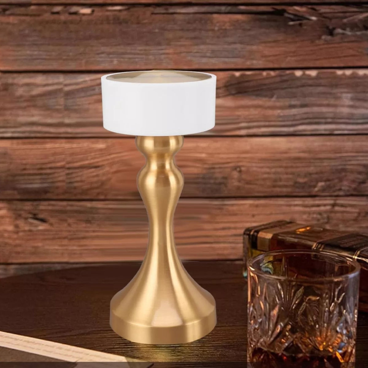 Luxury cordless LED table lamp featuring a brushed gold metal base with a minimalist white lampshade, ideal for bedside tables, restaurants, cafés, living rooms and modern designer interiors.