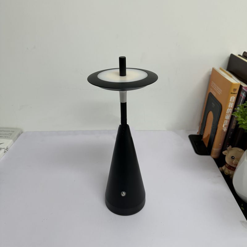 Modern cordless LED table lamp featuring a minimalist black conical base and floating circular shade, designed for ambient lighting in bedrooms, living rooms, offices, cafés and contemporary interiors.