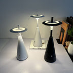 Modern cordless LED table lamp featuring a minimalist black conical base and floating circular shade, designed for ambient lighting in bedrooms, living rooms, offices, cafés and contemporary interiors.