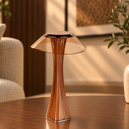 Contemporary cordless table lamp with pleated base and wide translucent shade.
