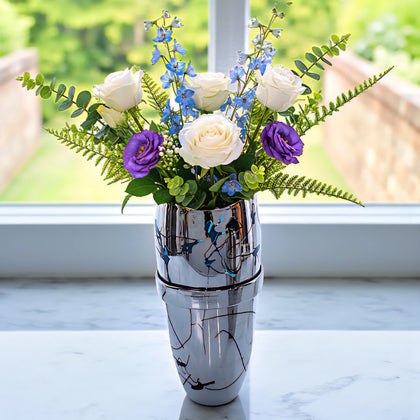 Silver splatter vase w/ white roses by window