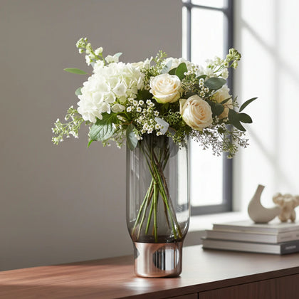 Modern grey vase, hydrangeas, sunlit sideboard