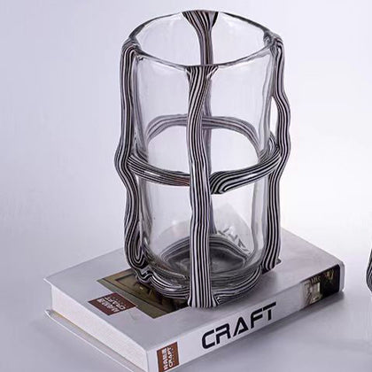 Tall ribbed cylinder vase on craft book