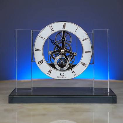 Skeleton clock, blue-lit dramatic front shot