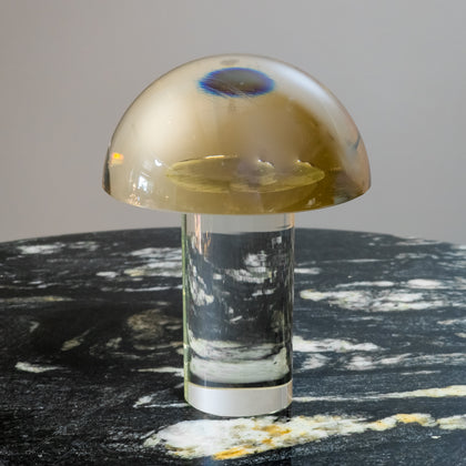 Mushroom-shaped lamp with gold top and clear base 