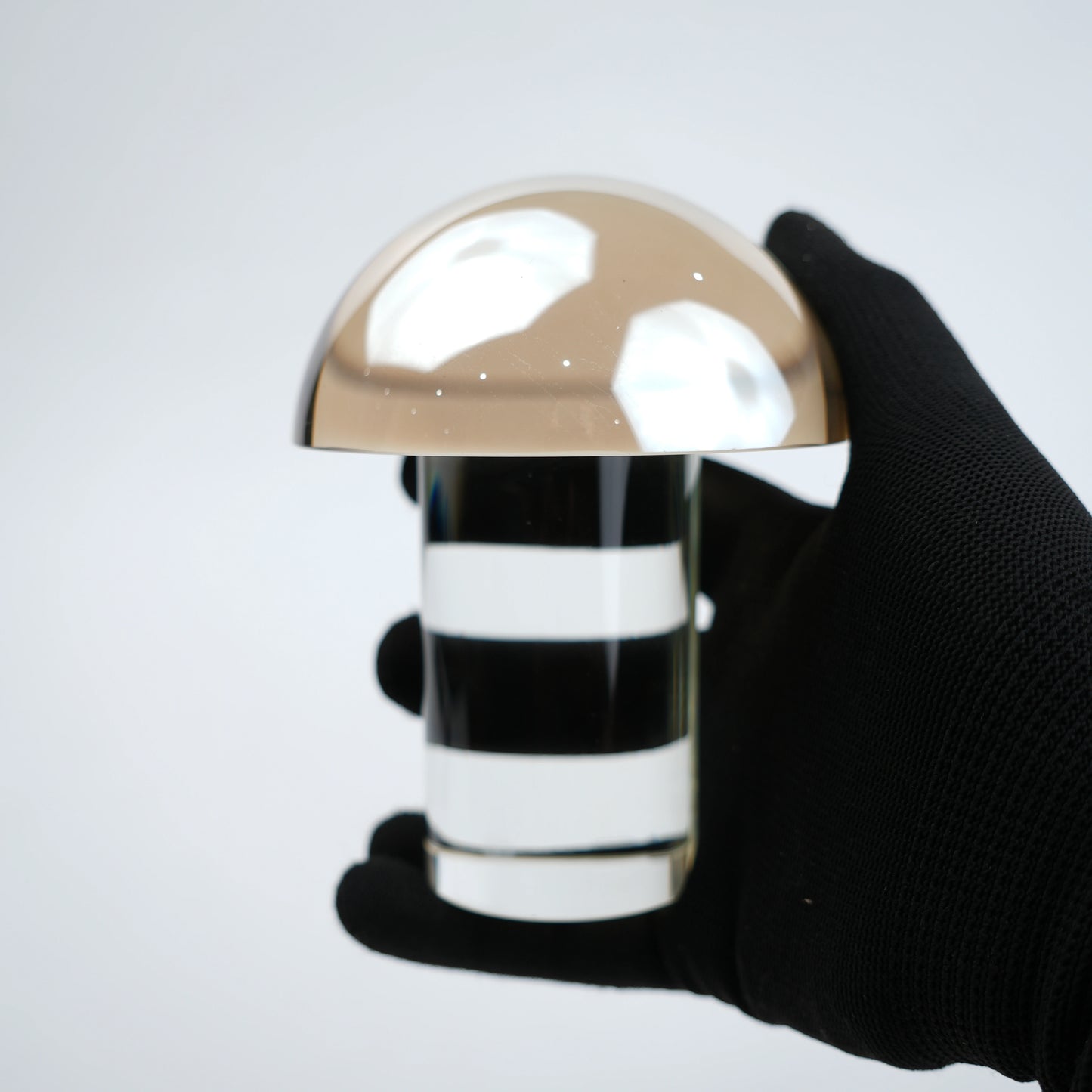 Mushroom-shaped lamp with gold top and clear base 