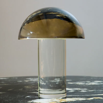 Mushroom-shaped lamp with gold top and clear base 