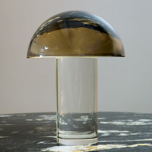 Mushroom-shaped lamp with gold top and clear base 