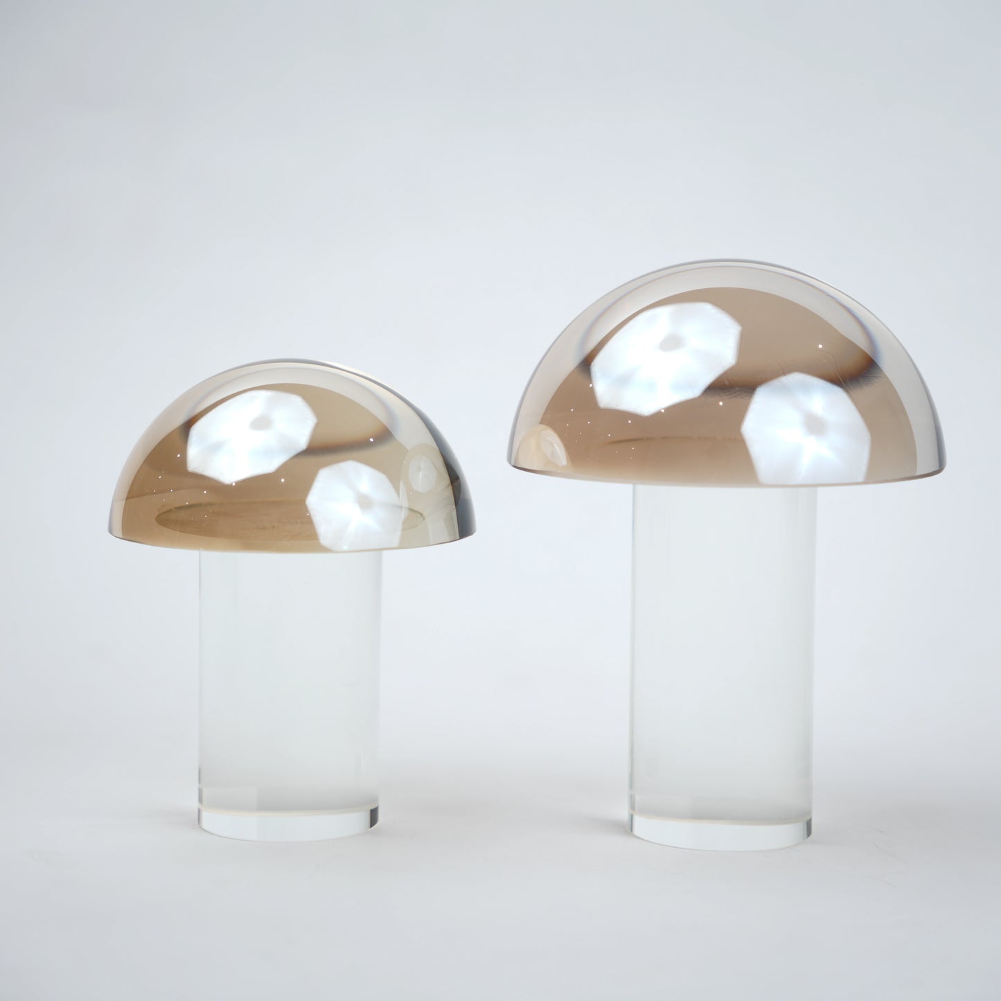 Mushroom-shaped lamp with gold top and clear base 