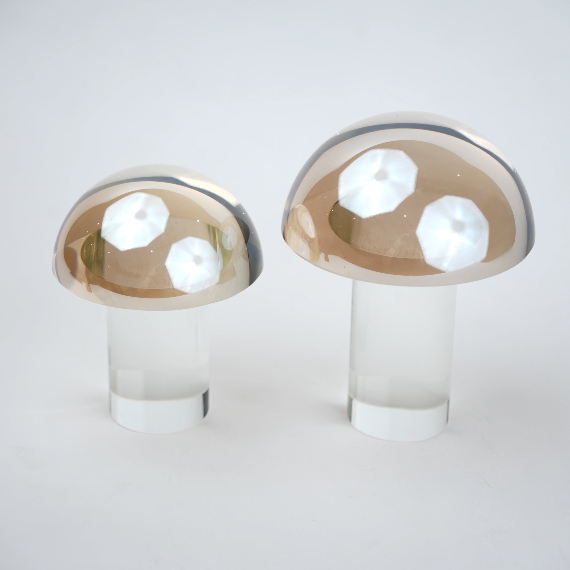 Mushroom-shaped lamp with gold top and clear base 