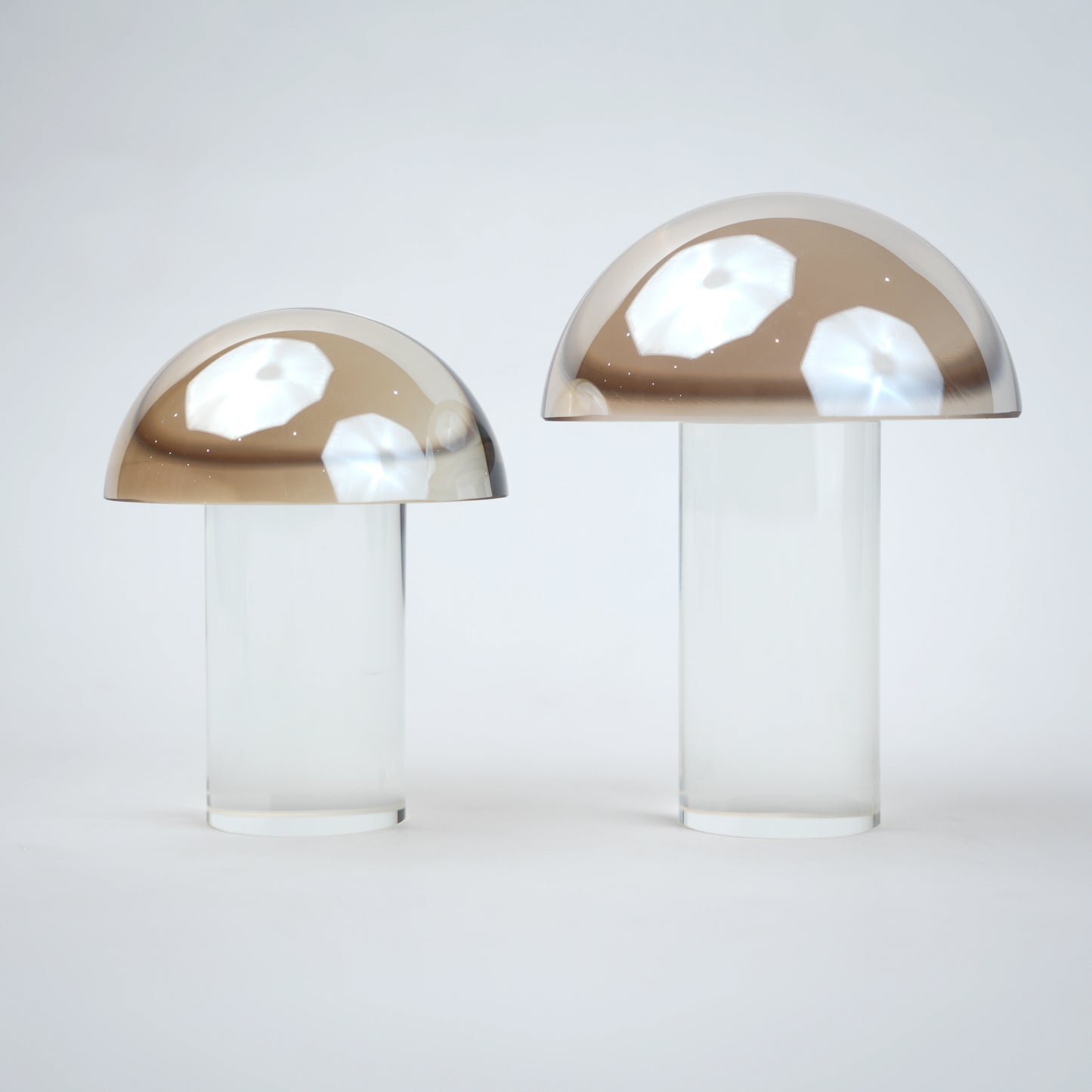 Mushroom-shaped lamp with gold top and clear base 