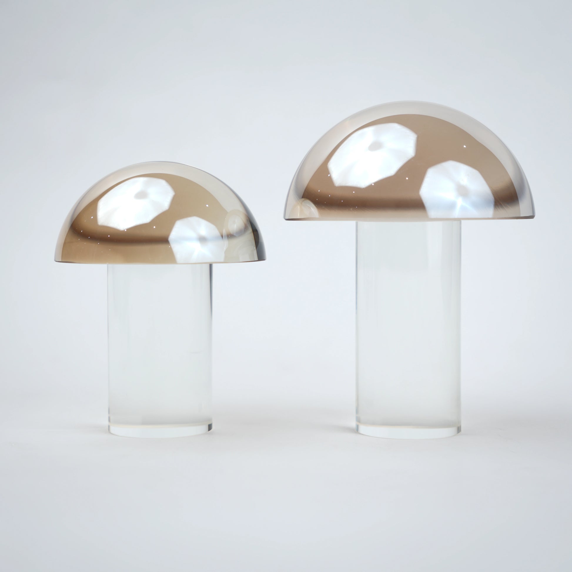 Mushroom-shaped lamp with gold top and clear base 
